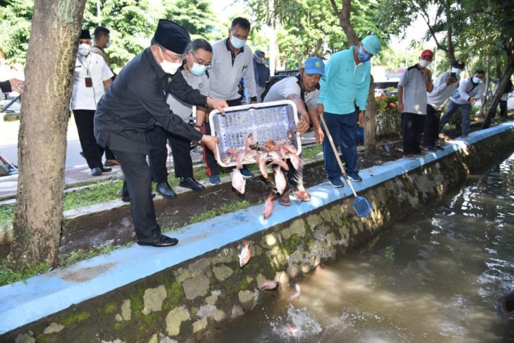 Pj Bupati Sidoarjo, Hudiyono bersama Dinas Perikanan Kabupaten Sidoarjo menebar 1000 benih ikan di saluran air dekat Pendopo Delta Wibawa, Jumat (22/1)/Foto: Kominfo Sidoarjo.
