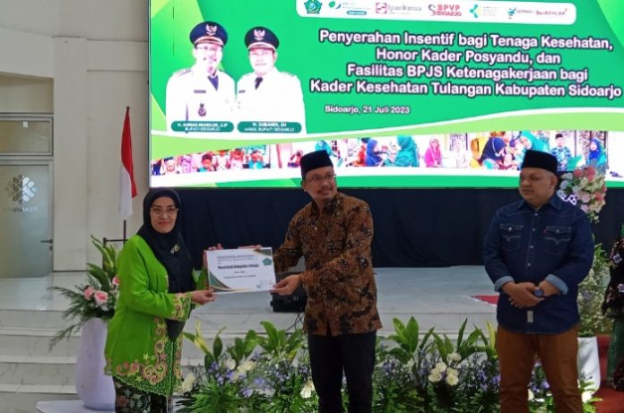 Suhartini kader kesehatan asal Desa Kepadangan RT 13 RW 05 Kecamatan Tulangan saat menerima insentif dari Bupati Sidoarjo Ahmad Muhdlor Ali / Foto : Ipung Syaiful