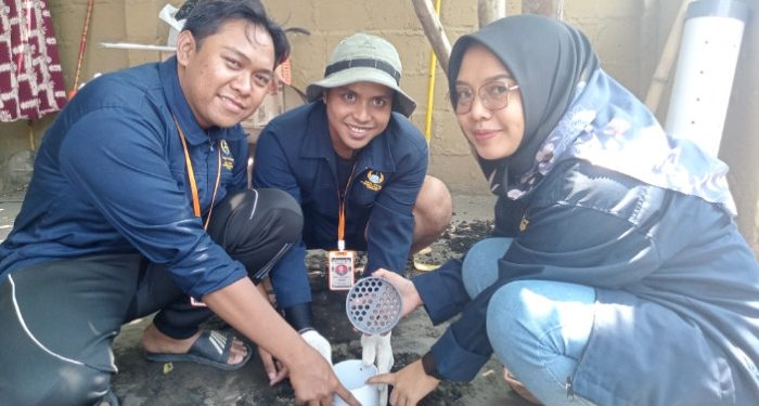 Mahasiswa KKN Unipa Surabaya saat memasuki biopori ke dalam tanah untuk resapan air dan mengolah sampah organik menjadi kompos di Desa Jatikalang Kecamatan Prambon, Sidoarjo / Foto: Ipung Syaiful