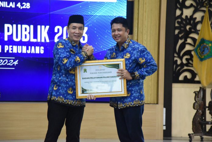 Pj Sekda Sidoarjo Andjar Surjadianto (kiri) saat memberikan penghargaan kepada kepala BPPD Sidoarjo Ari Suryono/Foto: Kominfo