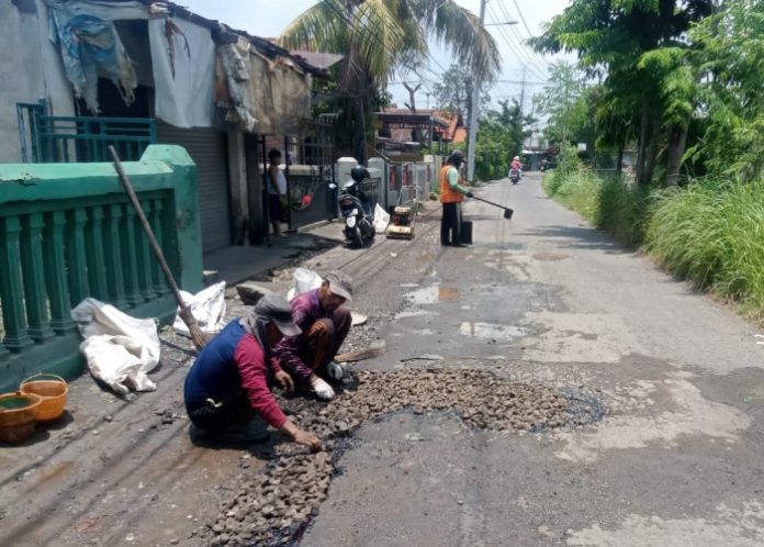 Satgas Jalan Dinas PU BMSDA Sidoarjo saat memperbaiki jalan rusak di Desa Jedong Cangkring Kecamatan Prambon/Foto: Istimewa