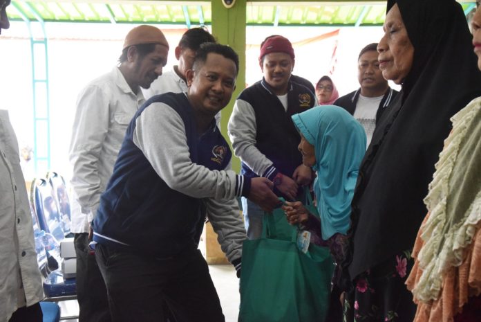 Ketua PWI Sidoarjo, Mustain, saat memberikan secara simbolis paket sembako kepada warga Tanggulangin/ Foto: PWI Sidoarjo