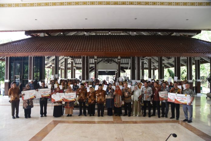 Sekda Fenny Apridawati saat menyerahkan SK dan santunan hari tua kepada salah satu PNS Pemkab Sidoarjo yang sudah memasuki usia pensiun / Foto: Kominfo Sidoarjo.